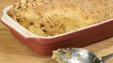 Apple Crumble with Spoon on Wooden Table