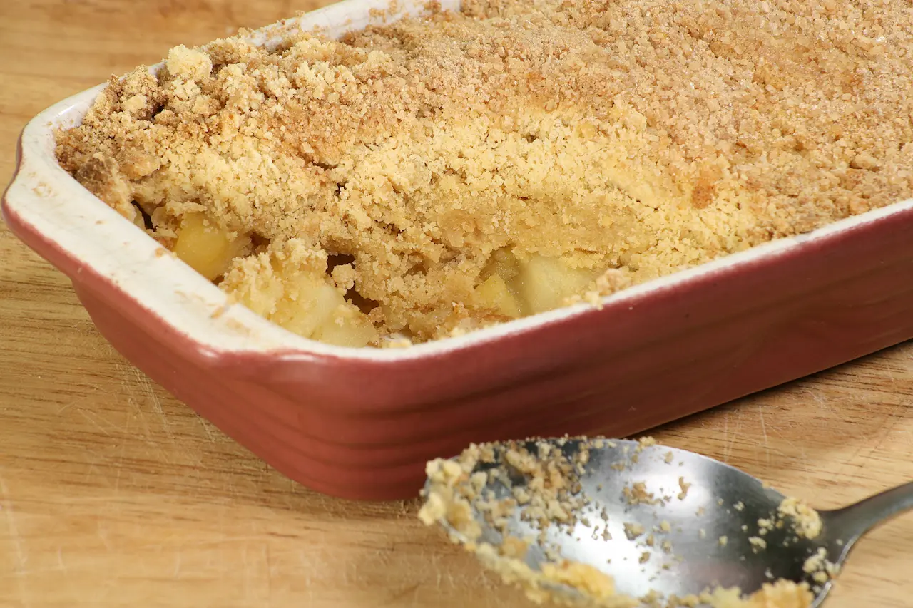 Apple Crumble with Spoon on Wooden Table