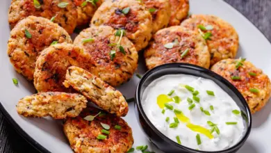 Cauliflower Patties on a White Plate with Sauce