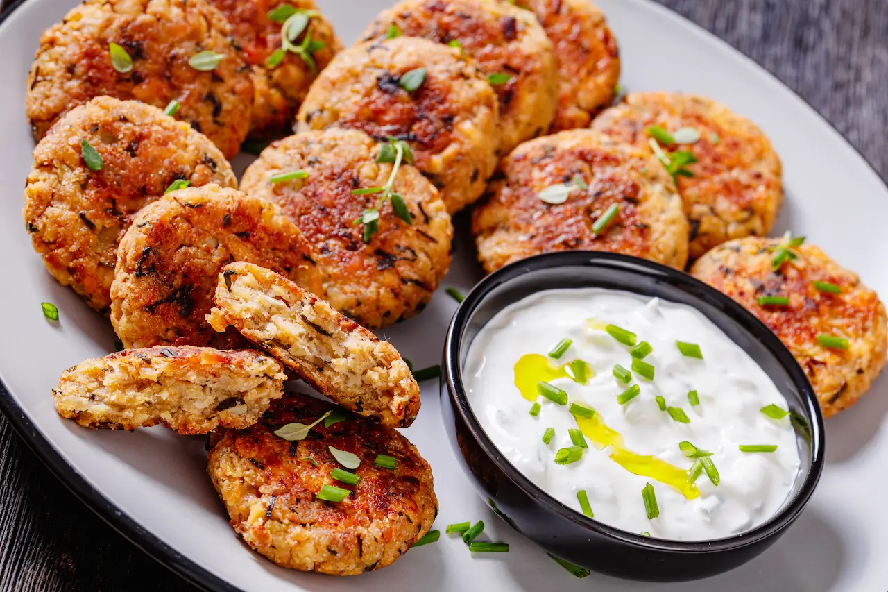 Cauliflower Patties on a White Plate with Sauce