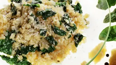 A Chicken, Pumpkin and Spinach Risotto On A Clear Plate