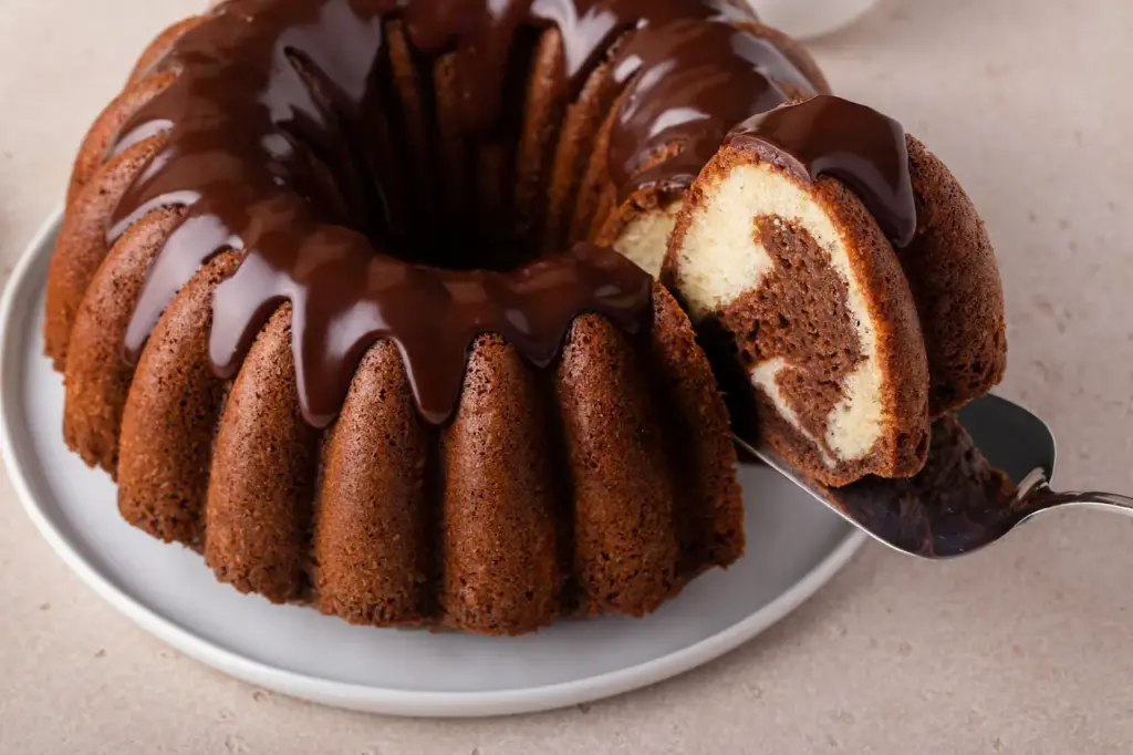 Chocolate Marble Bundt Cake on Top with a Slice Taken Out