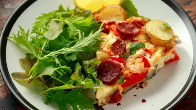 Chorizo Frittata with Salad on Black and White Plate