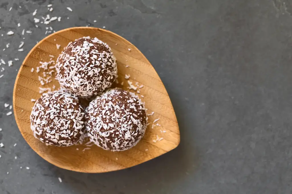 Coconut Rum Balls on Small Wooden Plate