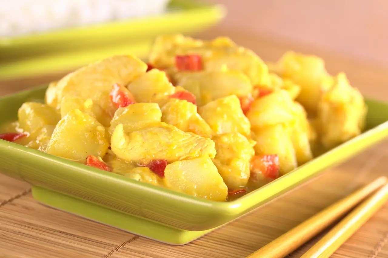 Indian Style Mango Chicken Curry On A Green Bowl