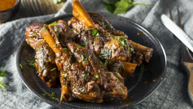 Lamb Shanks in Red Wine on a Black Plate