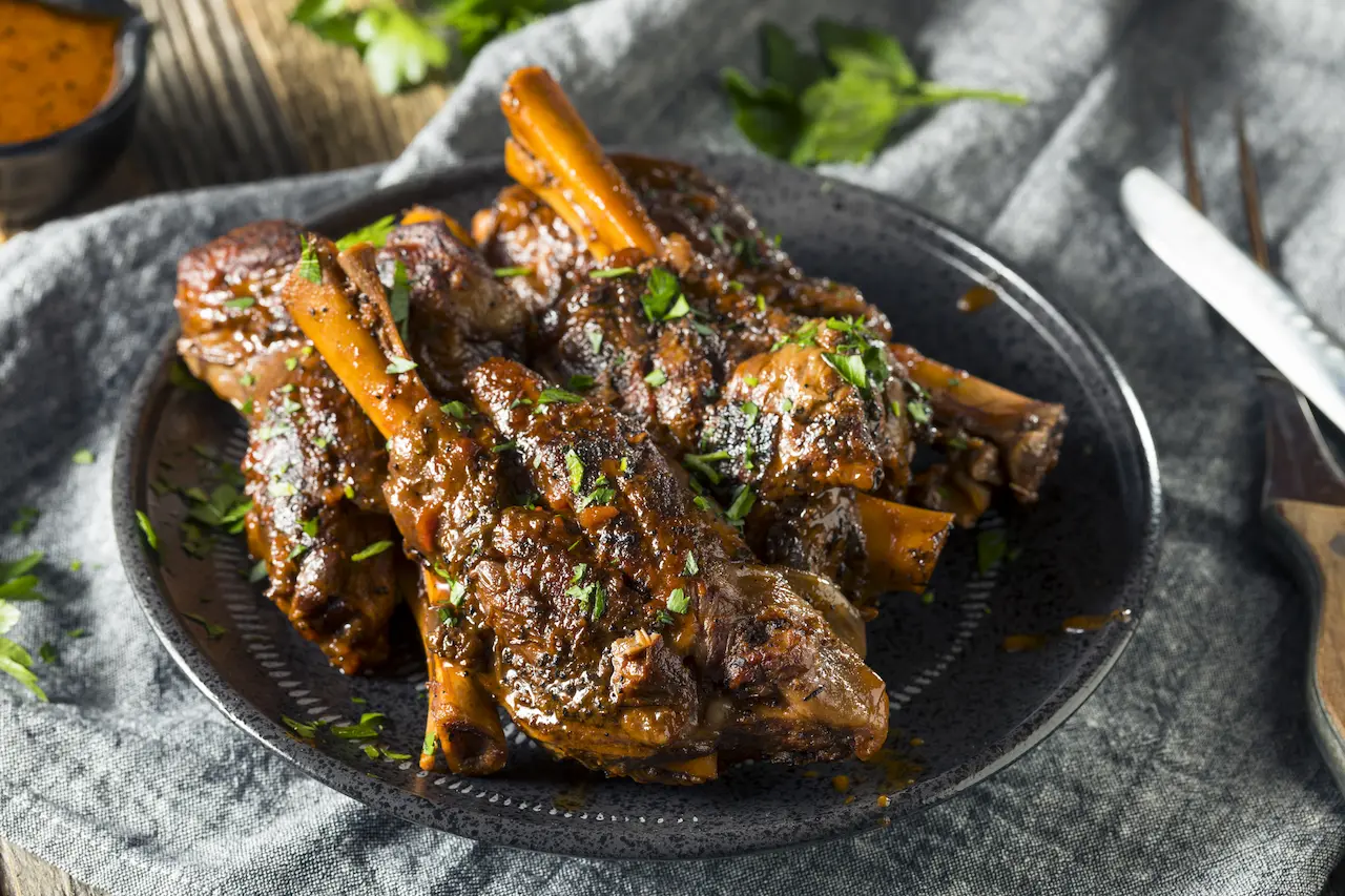 Lamb Shanks in Red Wine on a Black Plate