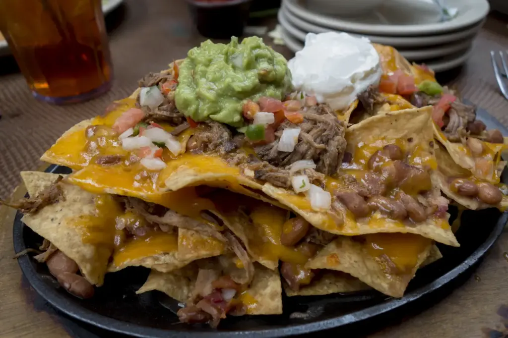 Plate of Layered Nachos with Cream on Top