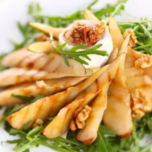 White Plate Filled with Roasted Pear and Rocket Salad