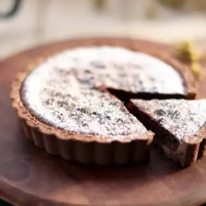 Salted Caramel Chocolate Tarts On A Wooden Plate