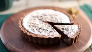 Salted Caramel Chocolate Tarts On A Wooden Plate