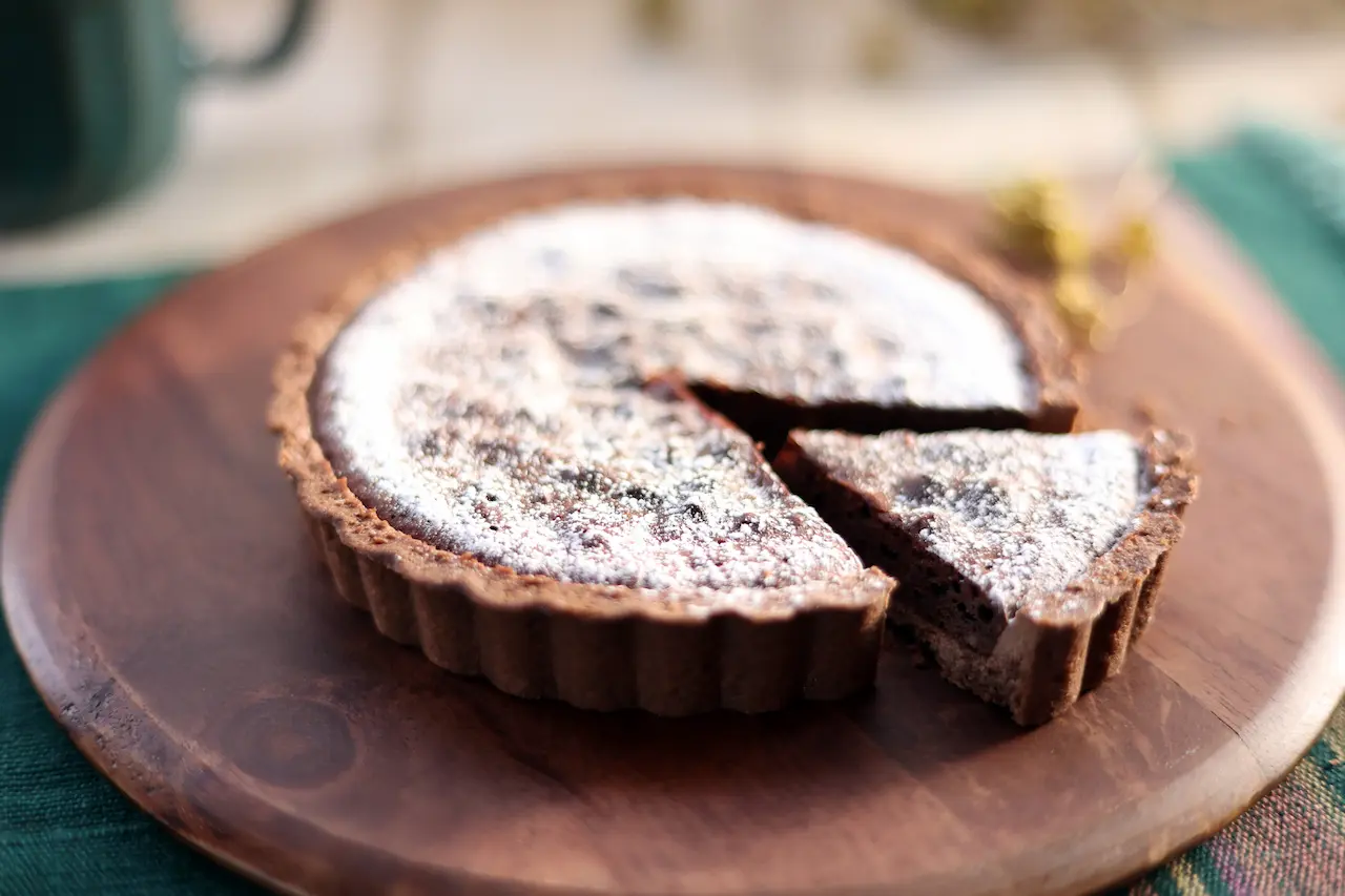 Salted Caramel Chocolate Tarts On A Wooden Plate