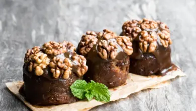 Sticky Date Puddings with Butterscotch Sauce on a Wooden Table