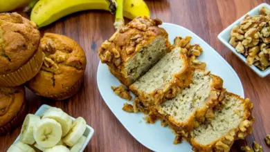 Uber-moist Banana Bread on a White Plate Next to Fresh Banana Cupcake