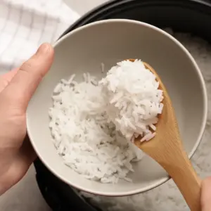 White Long Grain Rice in a Pressure Cooker Put in a White Bowl