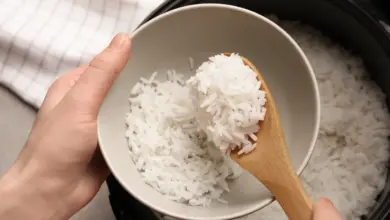 White Long Grain Rice in a Pressure Cooker Put in a White Bowl