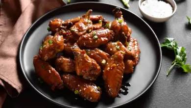 Honey Soy Chicken Wings on a Black Plate