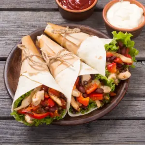 Mexican Chicken Burritos on Wooden Table