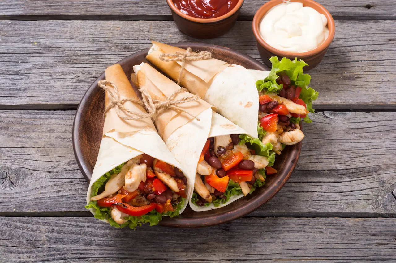 Mexican Chicken Burritos on Wooden Table