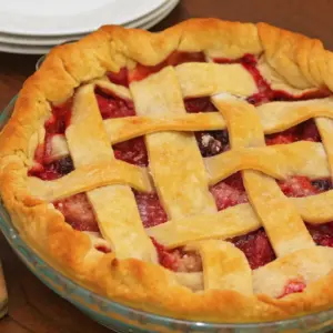 Three Berry Pie Next to a Knife