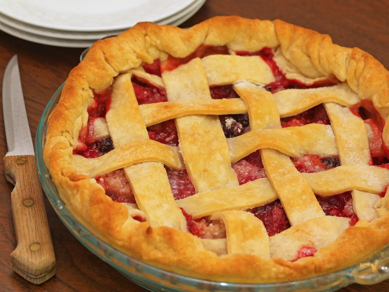 Three Berry Pie Next to a Knife